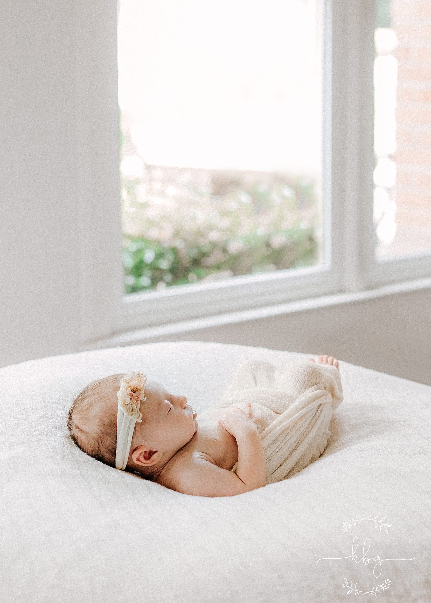 newborn girl posing on the beanbag - marietta newborn photographer