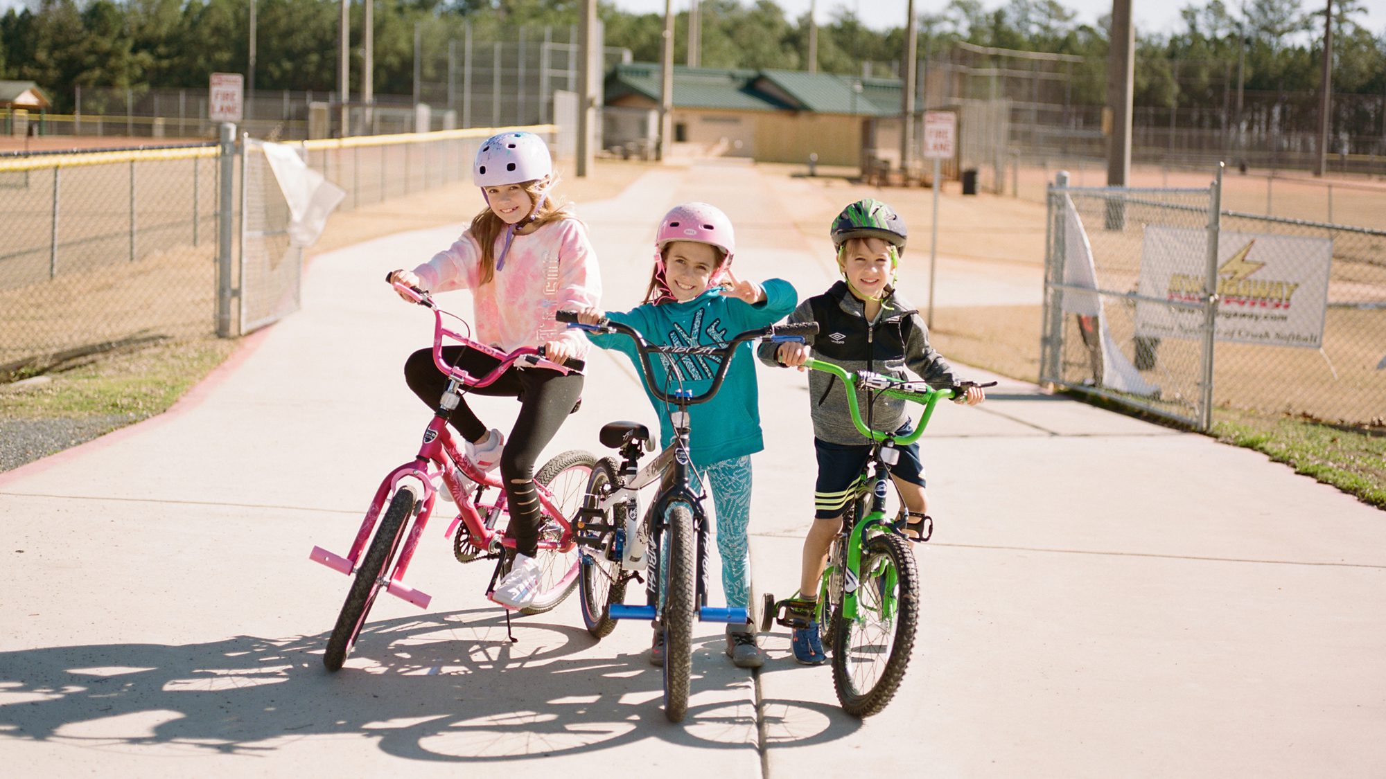 three kids on their bikes posing at Lost Mountain Park - Marietta Photographer