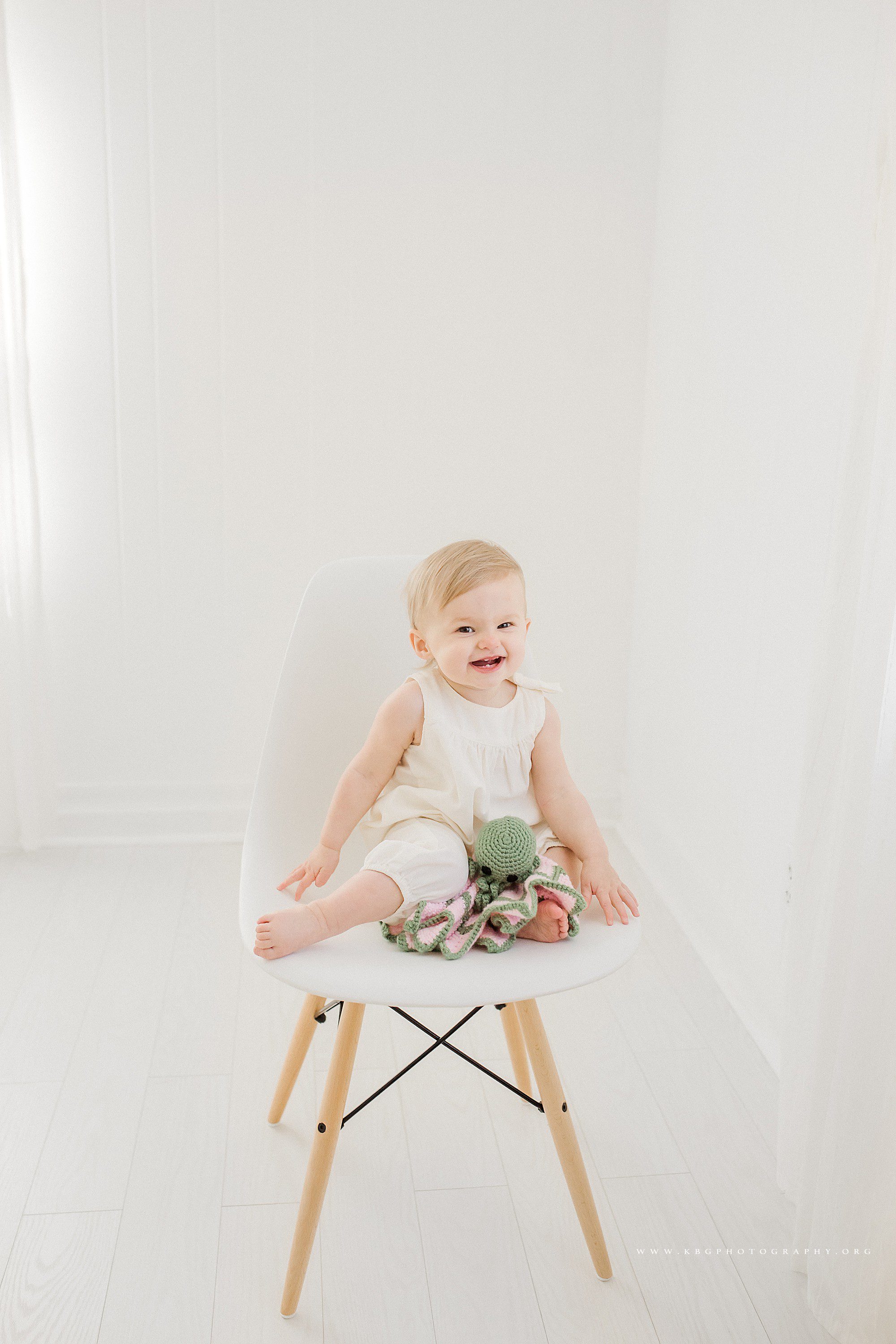 smyrna newborn photographer - one year old baby sitting in a white chair 