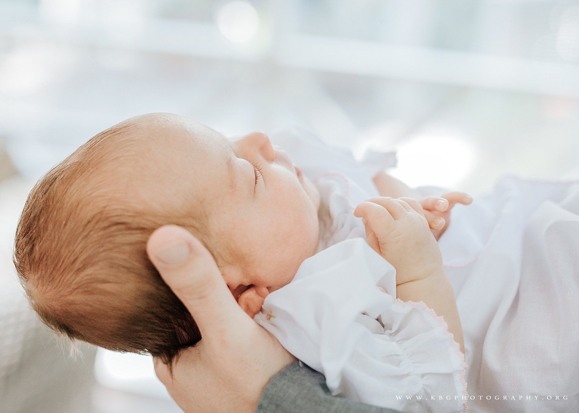 brookhaven newborn photographer - baby girl in dad's hands