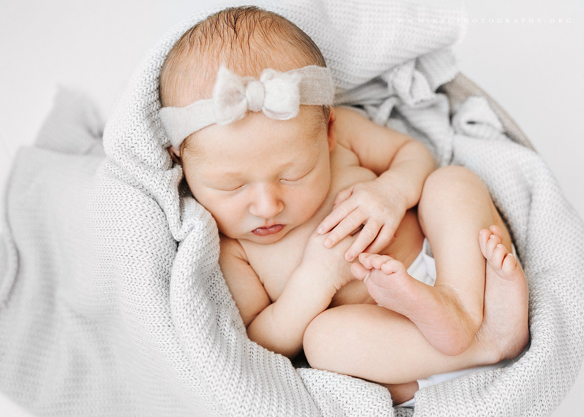 baby girl newborn posing in basket - marietta newborn session