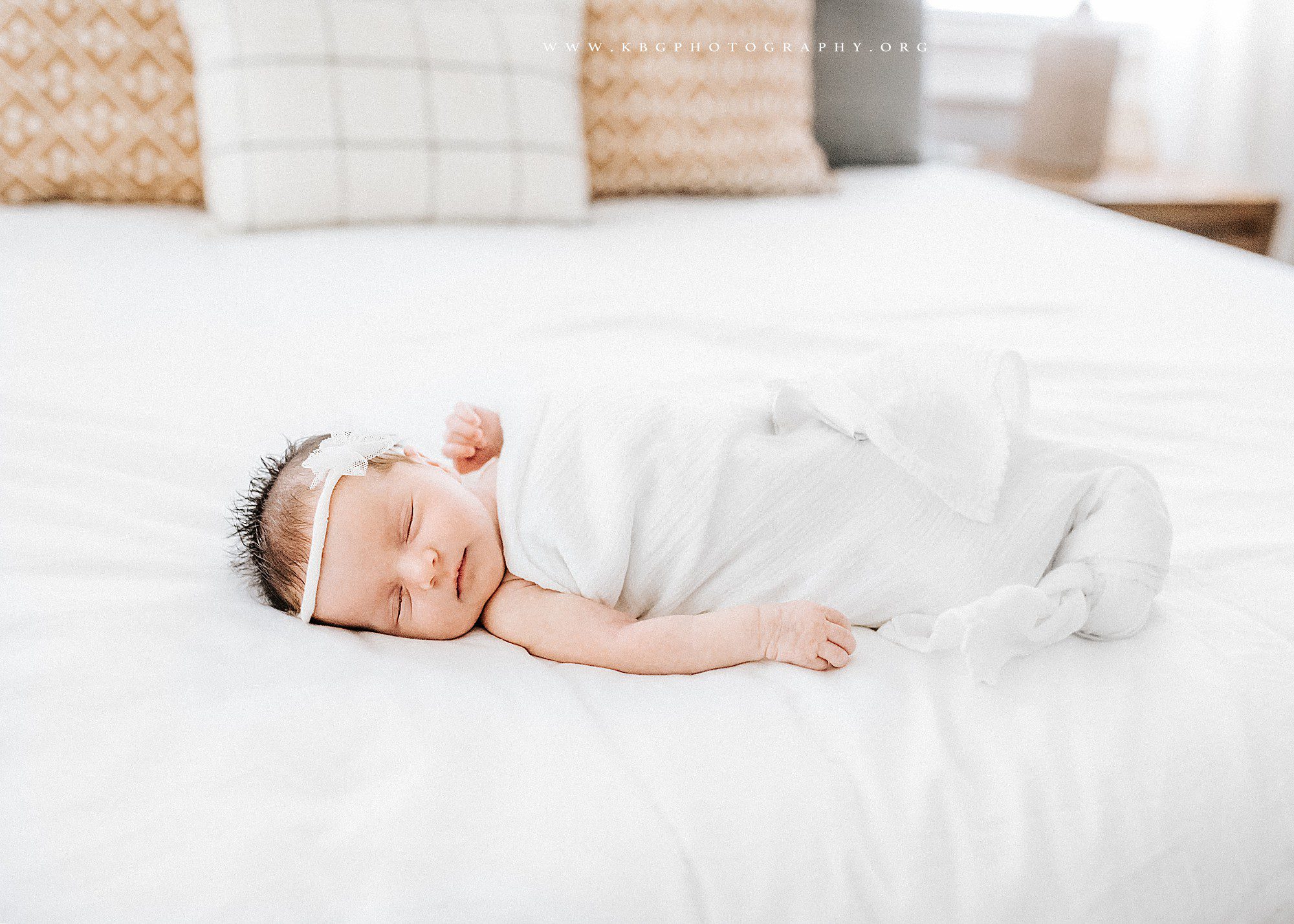 newborn girl on master bed - marietta baby photographer