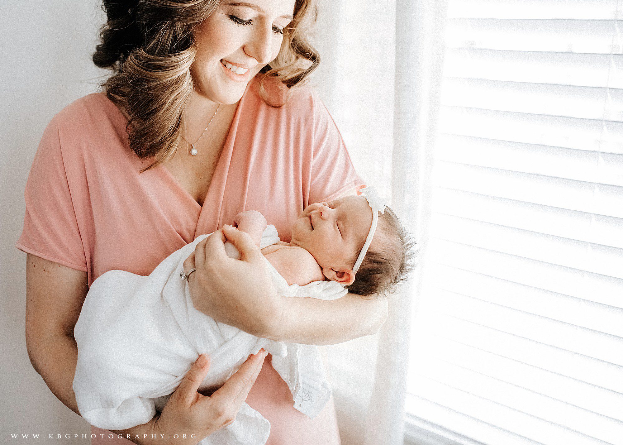mom with smiling newborn baby girl - marietta newborn photographer