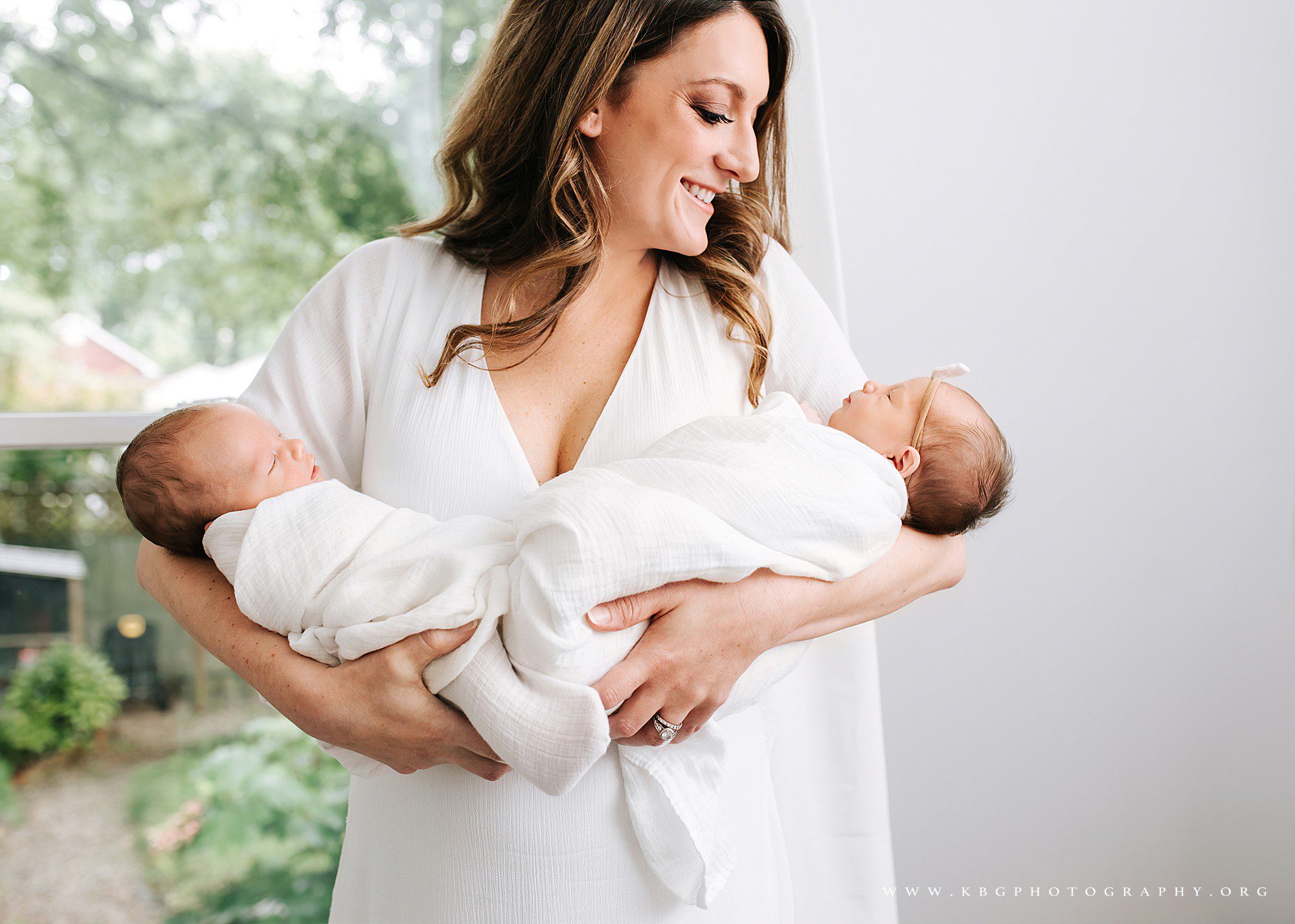 mom with twin babies in nursery - midtown atlanta photographer