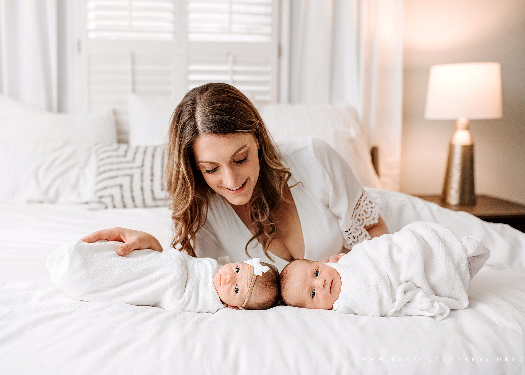 mom with twin babies on bed - atlanta newborn photographer