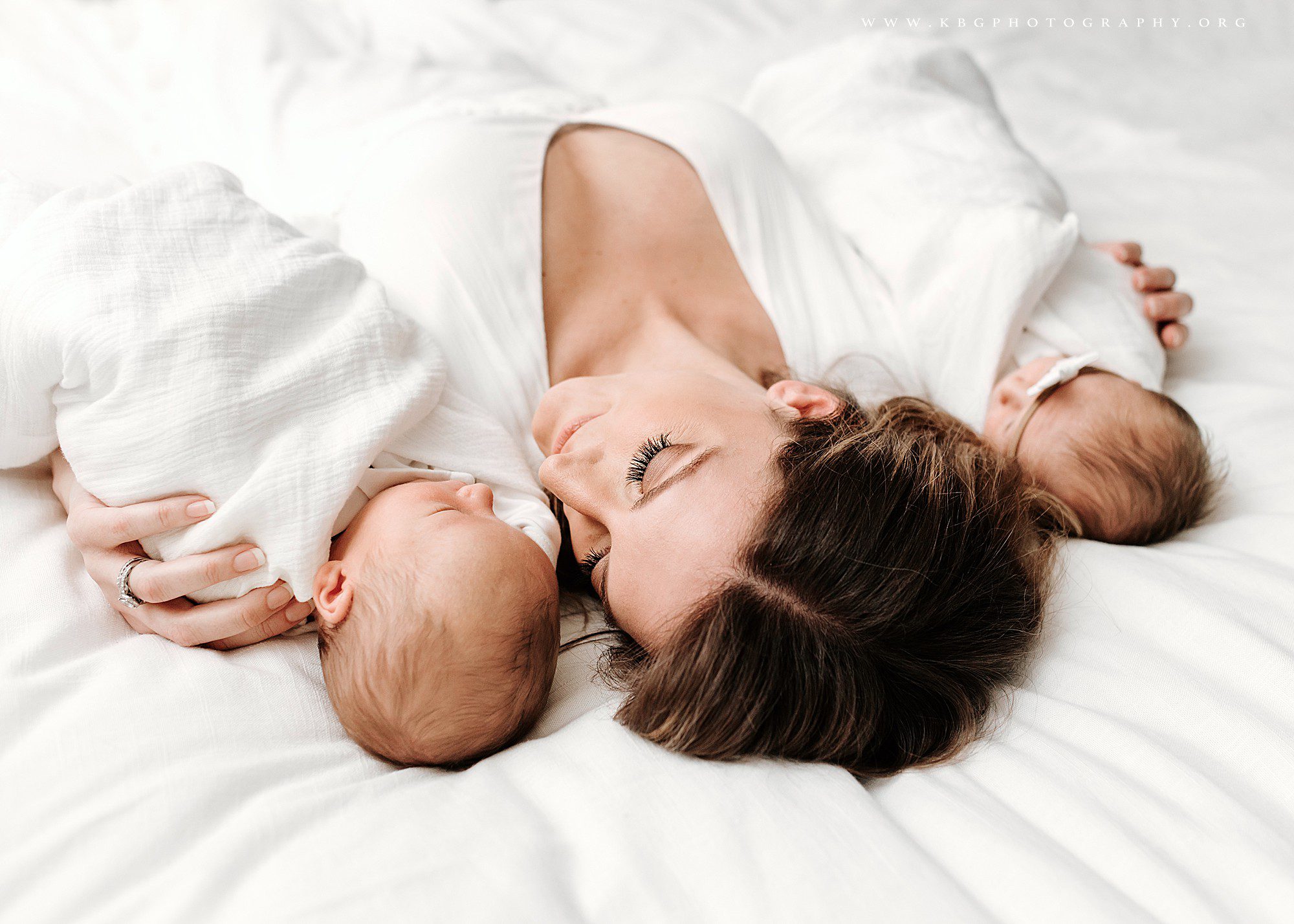 mom on bed with newborn twins - atlanta newborn photography 