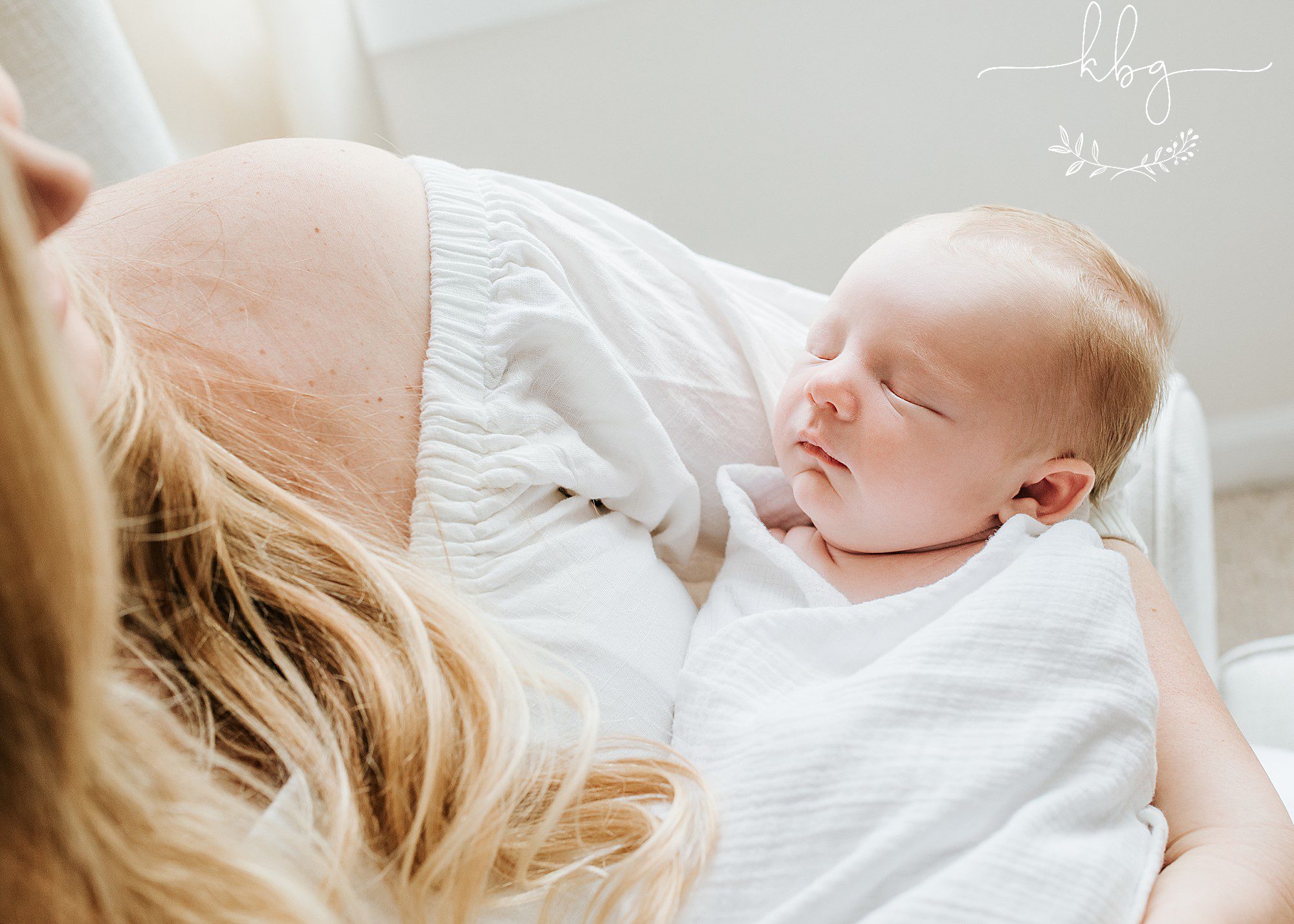 mama holding baby boy in nursery - east cobb in home newborn session