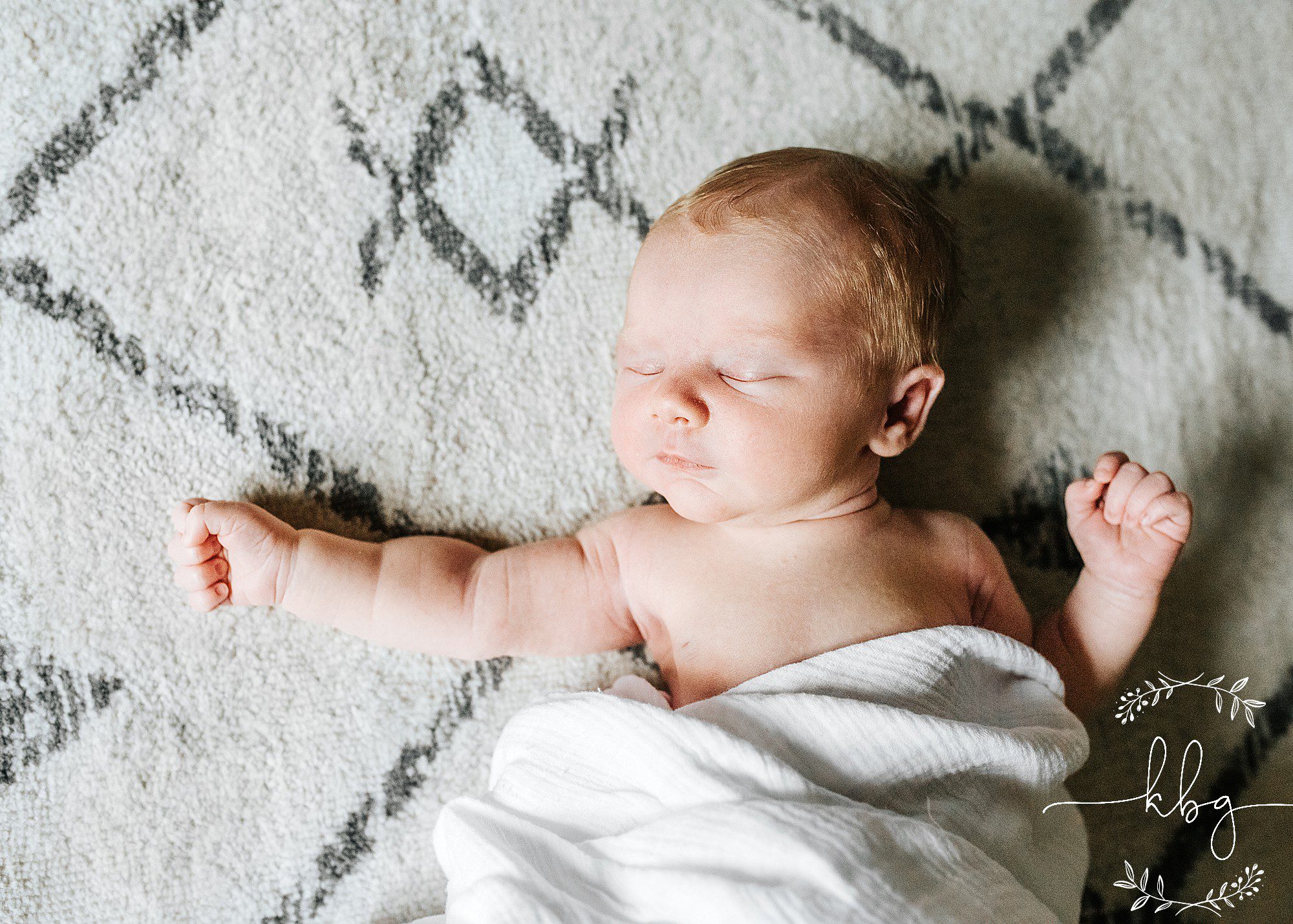 newborn baby boy laying on nursery rug - east cobb newborn photographer