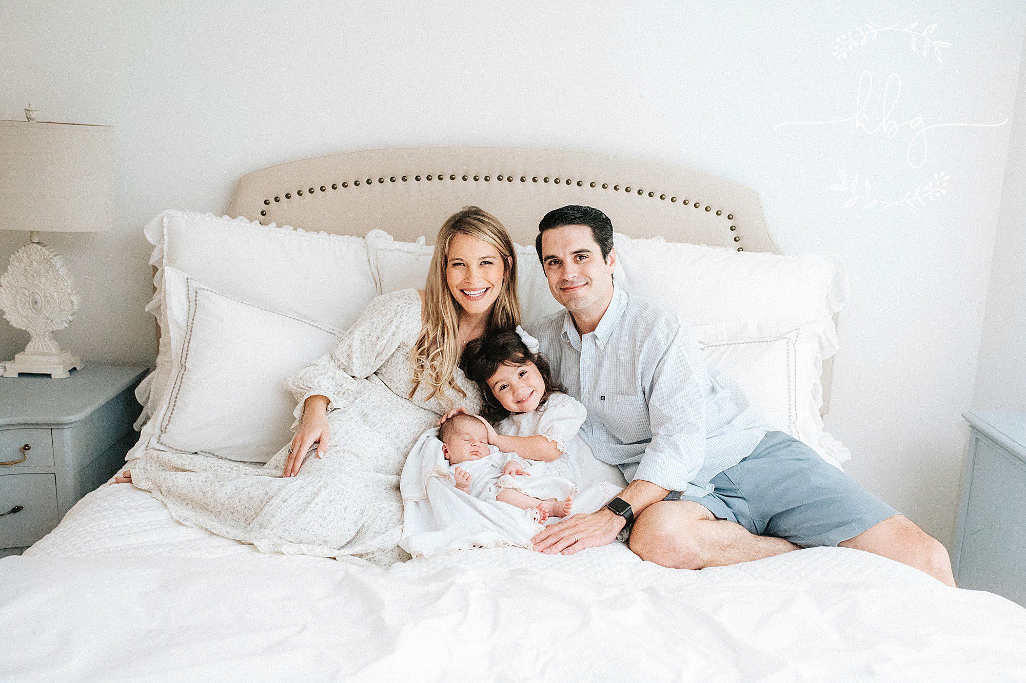 family of four posing on bed - atlanta family photographer